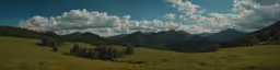 the mountains are dotted with trees and grass