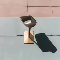 a silver chair sitting on top of a metal table