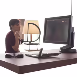 a lady that is looking at a computer screen
