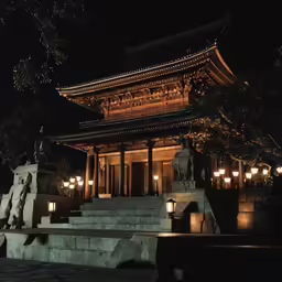 a lit up temple by some light posts