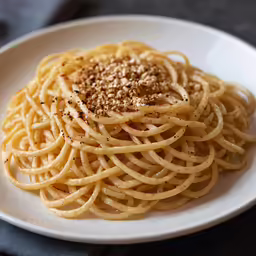 a white plate topped with noodles and seasoning
