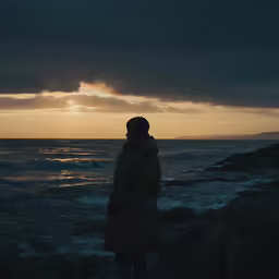 a person that is standing near the water