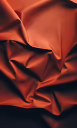 there is a red silk fabric that looks like it has some folds on top