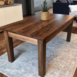 a large table with one end and a vase on top