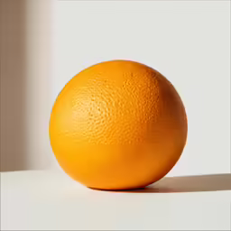 an orange is sitting on a table near a window