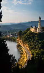 a road on the side of the water with a castle on top