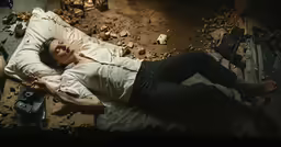 a person laying on the ground with a knife