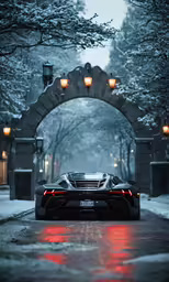 black sports car parked on snowy driveway at dusk
