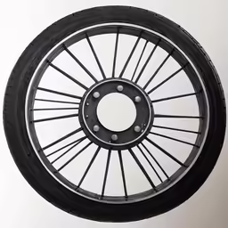spokes and black wheels are shown on a wall