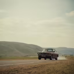 a vehicle driving on an open country road