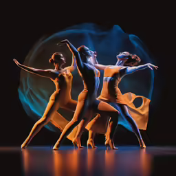 dancers posing with one another in front of a round object