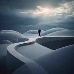 a lone man stands amongst many mounds in the middle of nowhere
