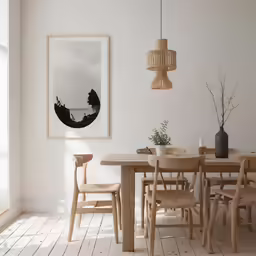 there is a painting hanging in the corner with a white background