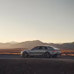there is a car on the road in the middle of the desert