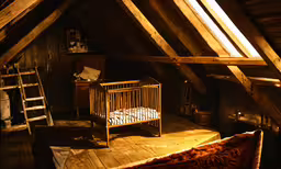 an attic has been converted into a loft with wood beams and beams,a baby
