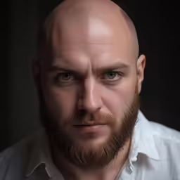 there is an adult man with a bald head