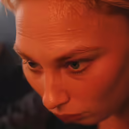 a girl with red hair staring at something in the distance