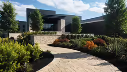 a courtyard that includes various trees, shrubs and plants