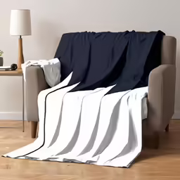 an unmade bed and chair in a room