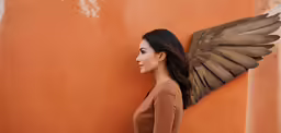 a young woman posing with a large wing on her back