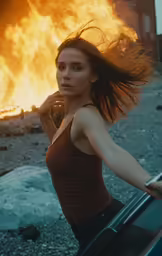 a woman leaning on a car with her hair blown