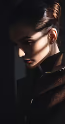 a woman standing wearing a dark coat is looking down