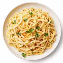 pasta with parsley is served in a white bowl
