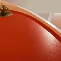 an orange and pink seat with a potted plant sitting inside
