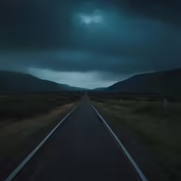 a long highway at the end of a mountain