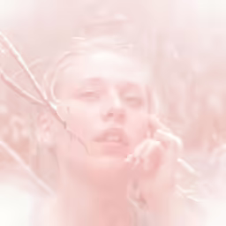 a blonde female with her chin resting on the nails of her fingers