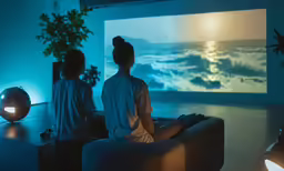 people sitting on a couch looking at an artwork in the back
