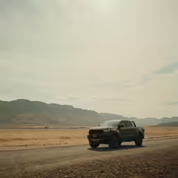 a jeep is parked in the middle of the desert