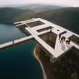 people walking across an open bridge above water