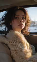 a woman sitting in the back seat of a car wearing a fuzzy coat