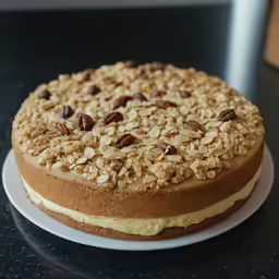 cake sitting on top of a black counter topped with white frosting