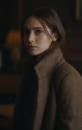a woman is photographed against the dark background