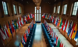 a banquet room with tables with many flags