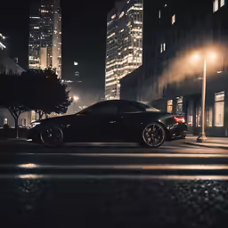 a luxury black sports car sits parked in the middle of a city at night
