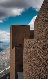 a tall brick building towering over a mountainous valley
