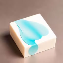 a white and blue block of soap on a gray surface