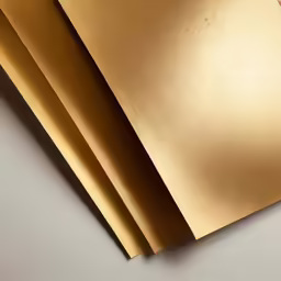 three pieces of paper in metallic finish with an open edge