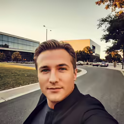 a man taking a selfie while standing on a road