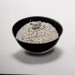 a black bowl with white and brown food inside