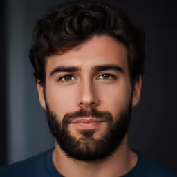 a close up of a young man with a beard