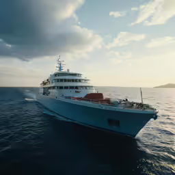 a large boat with several people on board in the ocean