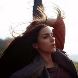 a woman in a park with her hair out