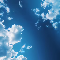 the blue sky and clouds are illuminated by sunlight