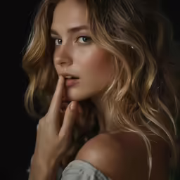 woman with wavy hair looking straight at camera