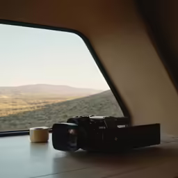 a camera is sitting on a table with a window