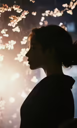 a woman standing in front of a window at night